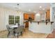 Cozy breakfast nook in kitchen with large window and adjacent breakfast bar featuring granite countertops at 2504 Korbel Ct, Waxhaw, NC 28173