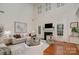 Bright living room with fireplace, large windows, hardwood floors and comfortable seating at 2504 Korbel Ct, Waxhaw, NC 28173