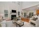 Open living room with fireplace, large windows and dining area with modern light fixture at 2504 Korbel Ct, Waxhaw, NC 28173