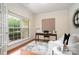 Cozy office space with hardwood flooring, a modern desk setup, and a comfortable seating area at 2504 Korbel Ct, Waxhaw, NC 28173