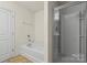 Bathroom featuring shower with glass door, bathtub, and neutral walls at 2515 Walnut Forest Dr, Charlotte, NC 28216
