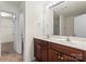 Bathroom featuring double sinks with dark wood cabinets and a large mirror at 2515 Walnut Forest Dr, Charlotte, NC 28216