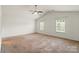 Bright bedroom features neutral walls, carpet flooring, vaulted ceilings, and a ceiling fan at 2515 Walnut Forest Dr, Charlotte, NC 28216
