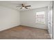 Neutral bedroom with a ceiling fan and a view from the window at 2515 Walnut Forest Dr, Charlotte, NC 28216