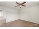 Neutral bedroom with a ceiling fan and a view from the window at 2515 Walnut Forest Dr, Charlotte, NC 28216