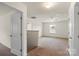 A carpeted bedroom with a view of the staircase and backyard at 2515 Walnut Forest Dr, Charlotte, NC 28216