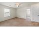A carpeted bedroom with a window and an open doorway at 2515 Walnut Forest Dr, Charlotte, NC 28216