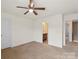 Bedroom featuring neutral walls, ceiling fan and doors to bathroom at 2515 Walnut Forest Dr, Charlotte, NC 28216