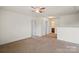 A carpeted bedroom with a ceiling fan and two doors leading to the hallway and bathroom at 2515 Walnut Forest Dr, Charlotte, NC 28216