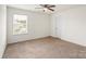 A neutral bedroom with a window and a ceiling fan at 2515 Walnut Forest Dr, Charlotte, NC 28216