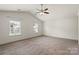Bright bedroom features neutral walls, carpet flooring, vaulted ceilings, and a ceiling fan at 2515 Walnut Forest Dr, Charlotte, NC 28216