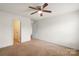Bedroom featuring neutral walls, ceiling fan and door to bathroom at 2515 Walnut Forest Dr, Charlotte, NC 28216