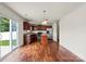Sunlit breakfast nook adjacent to the kitchen, featuring hardwood floors, sliding glass doors, and a modern light fixture at 2515 Walnut Forest Dr, Charlotte, NC 28216