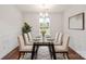 Elegant dining room with a glass table, wainscoting and contemporary light fixture at 2515 Walnut Forest Dr, Charlotte, NC 28216