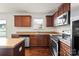 The kitchen has stainless steel appliances, wooden cabinets, and granite countertops at 2515 Walnut Forest Dr, Charlotte, NC 28216