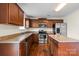 Well-lit kitchen features stainless steel appliances, brown cabinetry, and granite countertops at 2515 Walnut Forest Dr, Charlotte, NC 28216