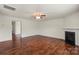 Spacious living room features hardwood floors, a fireplace, natural light, and access to another room at 2515 Walnut Forest Dr, Charlotte, NC 28216