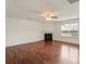 Living room features hardwood floors, a fireplace, crown molding, base molding, and a neutral color palette at 2515 Walnut Forest Dr, Charlotte, NC 28216