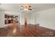 Hardwood floors span an open-concept floorplan featuring a full kitchen, living room, ceiling fan, and natural light at 2515 Walnut Forest Dr, Charlotte, NC 28216
