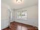 Elegant office with hardwood floors, wainscoting, a large window, and French doors at 2515 Walnut Forest Dr, Charlotte, NC 28216