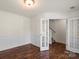 Bright office space featuring hardwood floors, white trim, and double French doors at 2515 Walnut Forest Dr, Charlotte, NC 28216