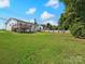 Expansive backyard showcasing a well-manicured lawn and a charming deck for outdoor enjoyment at 2633 N Sharon Amity Rd, Charlotte, NC 28205