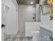 Updated bathroom with a tiled shower, stylish vanity, and patterned tile flooring at 2633 N Sharon Amity Rd, Charlotte, NC 28205