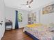 Cozy bedroom featuring hardwood floors, a floral bedspread, and a bright window view at 2633 N Sharon Amity Rd, Charlotte, NC 28205
