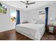 Charming bedroom featuring hardwood floors, large windows, and a comfortable bed with plush pillows at 2633 N Sharon Amity Rd, Charlotte, NC 28205