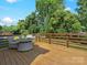 Spacious wood deck with outdoor seating, perfect for entertaining or relaxing in a private backyard setting at 2633 N Sharon Amity Rd, Charlotte, NC 28205