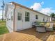 Cozy outdoor space featuring a well-maintained wooden deck with comfortable seating and white exterior home details at 2633 N Sharon Amity Rd, Charlotte, NC 28205