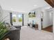 Stylish living room offering comfortable seating, large windows, and a mounted television at 2633 N Sharon Amity Rd, Charlotte, NC 28205