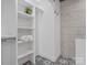 Organized walk-in closet featuring built-in shelves and ample storage space at 2633 N Sharon Amity Rd, Charlotte, NC 28205