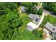 Aerial view of home with solar panels, lush landscaping, and detached garage at 2715 Kennetuck Ct, Charlotte, NC 28273