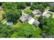 Aerial view of home showcasing lush landscaping, large driveway, and detached garage at 2715 Kennetuck Ct, Charlotte, NC 28273
