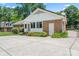 Brick and vinyl siding home featuring a back yard, concrete patio, and lush landscaping at 2715 Kennetuck Ct, Charlotte, NC 28273