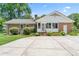 Brick and vinyl siding home featuring a back yard, concrete patio, and lush landscaping at 2715 Kennetuck Ct, Charlotte, NC 28273