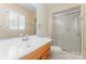 Bathroom featuring a vanity with drawers, glass shower door, and large mirror with bright lighting at 2715 Kennetuck Ct, Charlotte, NC 28273