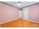 Bedroom with hardwood floors, standard closet door, and view into connecting room at 2715 Kennetuck Ct, Charlotte, NC 28273