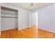 Bedroom with hardwood floors, and an open closet door revealing shelves and a hanging rod at 2715 Kennetuck Ct, Charlotte, NC 28273
