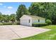 Detached garage with a large parking pad and green lawn at 2715 Kennetuck Ct, Charlotte, NC 28273