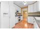 Kitchen featuring white cabinets, modern appliances, and charming wallpaper at 2715 Kennetuck Ct, Charlotte, NC 28273