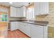 Charming kitchen with white cabinets, laminate countertops, and vintage wallpaper at 2715 Kennetuck Ct, Charlotte, NC 28273