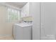 Functional laundry room with washer, dryer, storage, and natural light at 2715 Kennetuck Ct, Charlotte, NC 28273