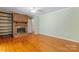 Living room with hardwood floors, fireplace, and built-in shelving at 2715 Kennetuck Ct, Charlotte, NC 28273