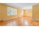 Bright living room featuring hardwood floors and large windows at 2715 Kennetuck Ct, Charlotte, NC 28273