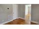 Cozy bedroom featuring beautiful hardwood floors, neutral walls, and crisp white trim at 2820 Bellhaven Cir, Charlotte, NC 28214