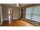 This bedroom has wood floors, ceiling fan, and a doorway leading to another room at 2820 Bellhaven Cir, Charlotte, NC 28214