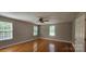 Bright bedroom featuring hardwood floors, a ceiling fan, and plenty of natural light from two windows at 2820 Bellhaven Cir, Charlotte, NC 28214