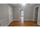 This bedroom has wood floors, ceiling fan, and a doorway leading to another room at 2820 Bellhaven Cir, Charlotte, NC 28214